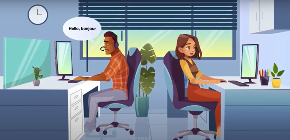 Image of two employees working at their desks. One employee says "Hello, bonjour".